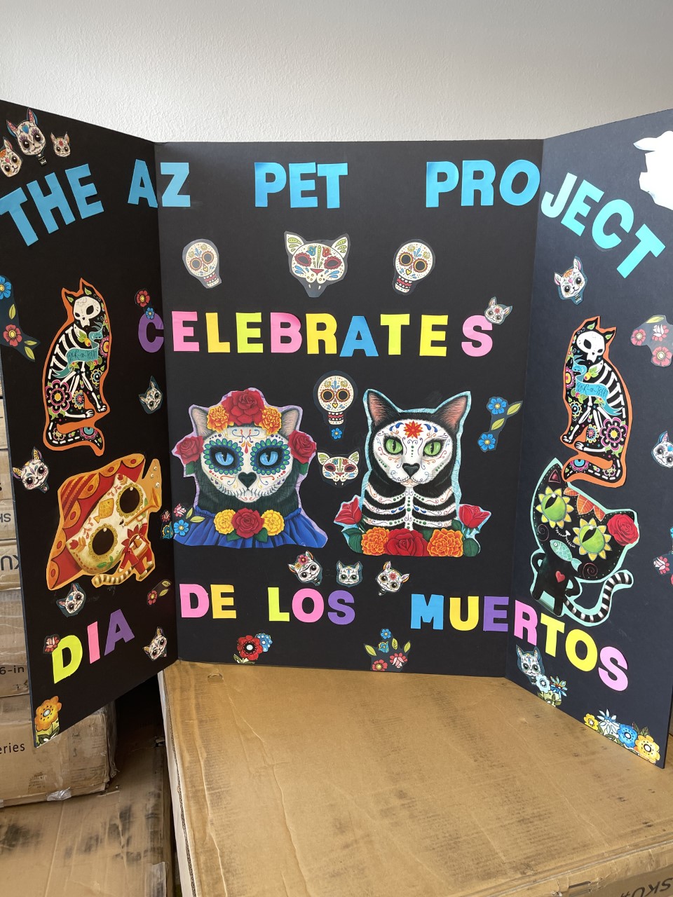 tri-fold poster that reads The AZ Pet Project Celebrates Dia de Los Muertos with sugar skull cats and dogs on it