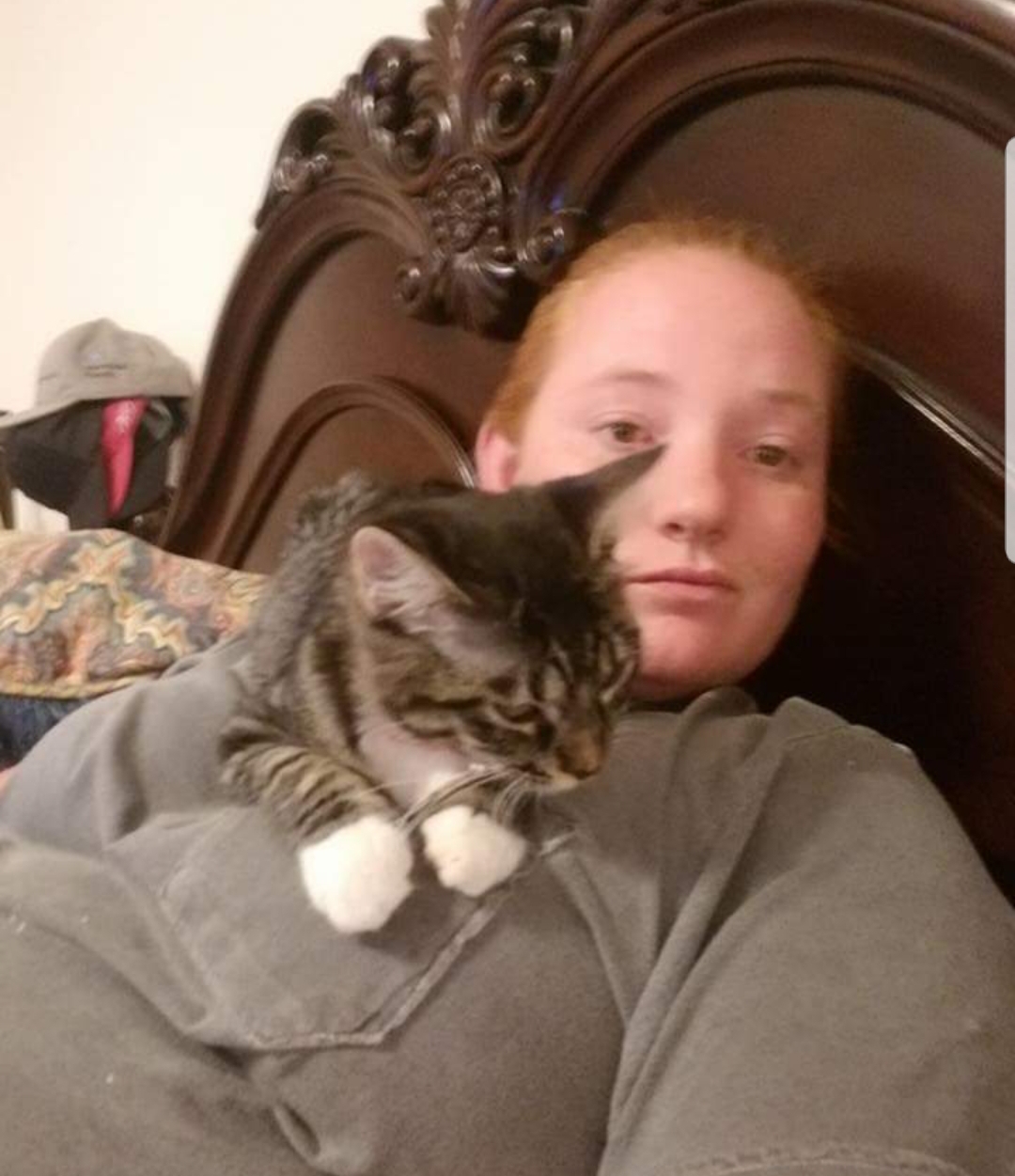 woman taking a selfie with her dog sitting on the couch