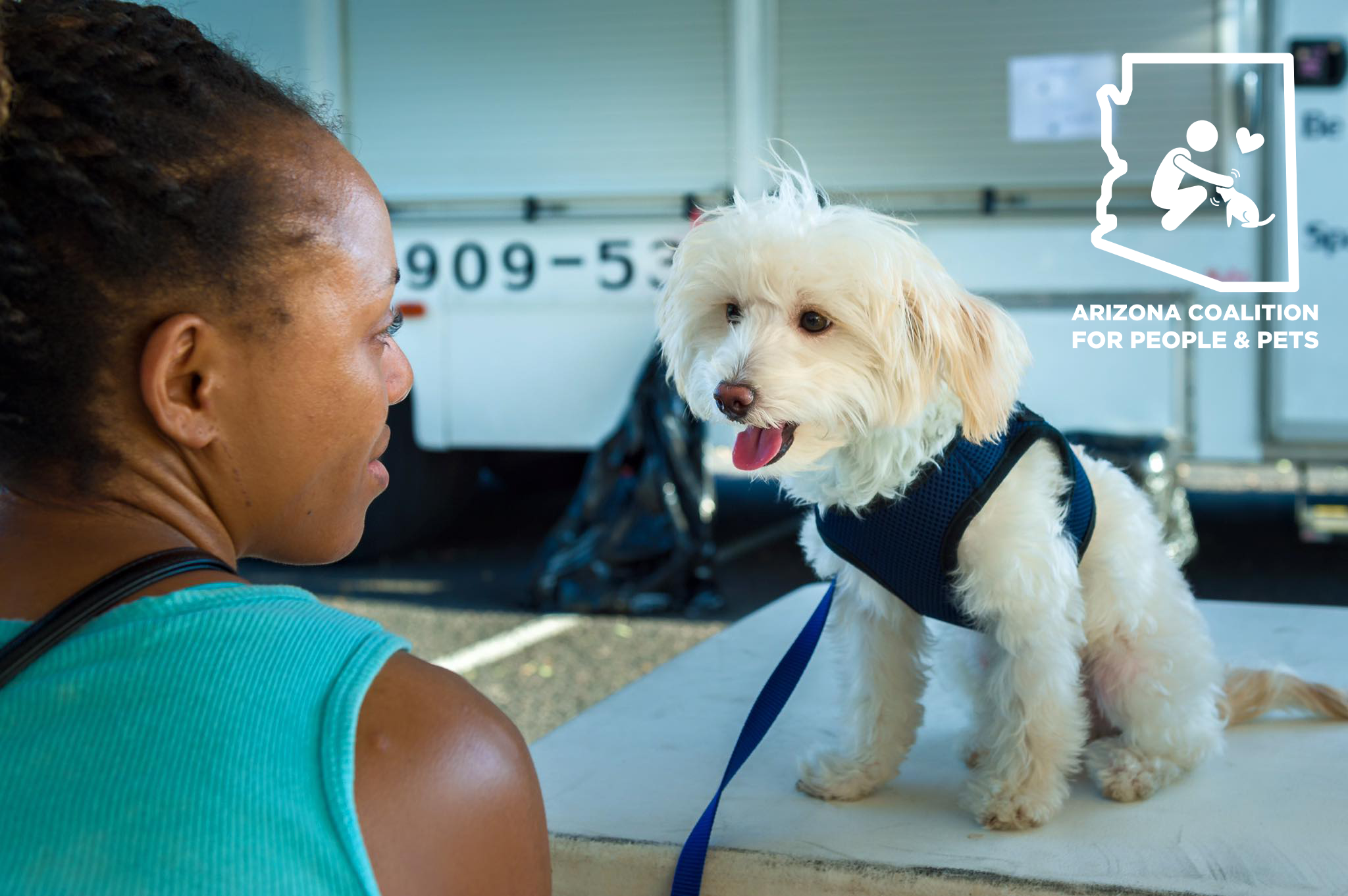 Woman with white, fluffy dog and Arizona Coalition for People and Pets logo