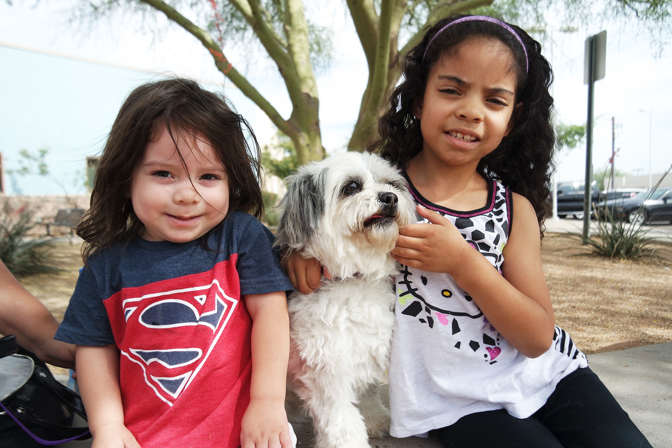 two kids with dog